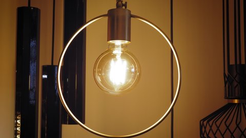 turning off the lamp, chandelier. close-up. bulb with Edison filament. incandescent lamp. the vintage style lamp bulb with Edison filament is switching off and on.