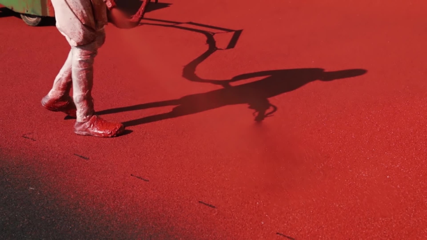 applying paint on the treadmill at the stadium
