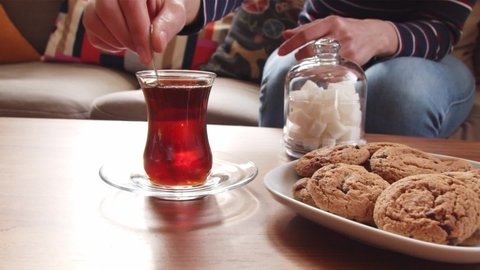 Stirring traditional Turkish tea at home