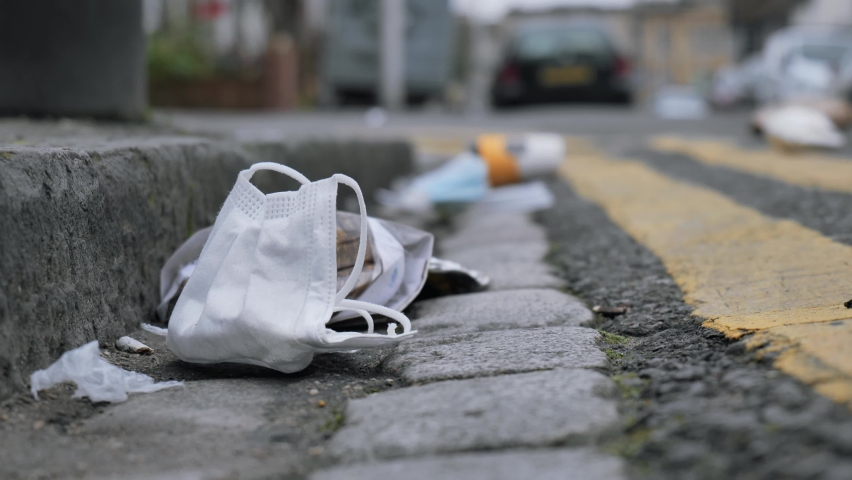 Medical face mask and other litter in the street during the Coronavirus pandemic, UK Royalty-Free Stock Footage #1067940485