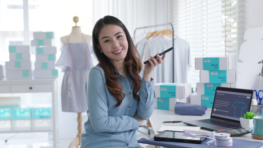 Portrait young attractive asia female owner startup business look at camera work happy with box at home prepare parcel delivery in sme supply chain, procurement, omnichannel commerce online concept. | Shutterstock HD Video #1067943191