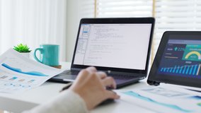 Back rear view of young asian woman, freelance data scientist work remotely at home coding programing on Big data mining, AI data engineering, IT Technician Works on Artificial Intelligence Project. - Powered by Shutterstock - Get 15% off with code: PIKWIZARD15