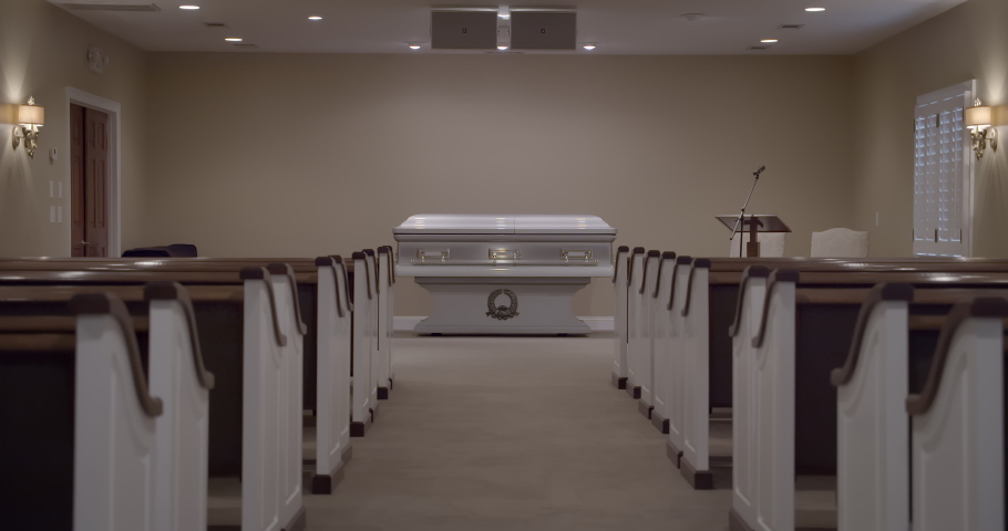 Funeral with casket in empty church chapel with no people due to covid pandemic. | Shutterstock HD Video #1067945708
