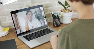 Young woman waving hand and talking on video call with colleague via laptop computer at home, mobile job and remote working concepts