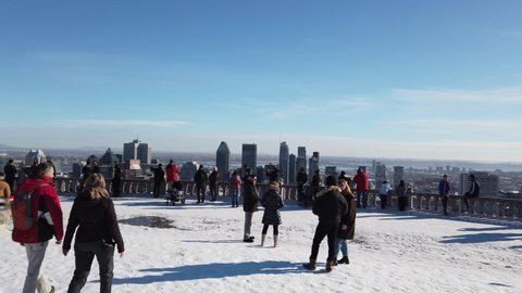 Montreal , Quebec , Canada - 01 09 2021: People enyoing the view of Montreal from the lookout at the Mont Roal Park of Montreal 