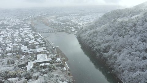 Snowfall over Kyoto, Arashiyama area and Togetsu-kyo Bridge, Aerial View