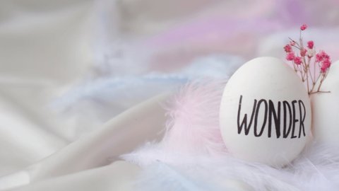 Easter DIY. Do it yourself. Trendy Easter Eggs Composition. Egg name settings. Words drawn with pen. Pastel colors. Love Live Believe Wonder Hope. Handmade eggs decoration