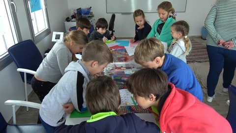Fethiye, Turkey - 26th of January 2021: 4K English winter camp at the IBC - European children try to solve Chinese alphabet
