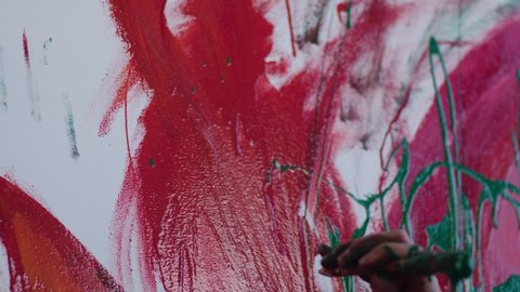 Someone draws paint on a white sheet. close-up of a tassel. 4k, slow motion. Canvas Being Painted by Master. Paint Dripping Over A Paintbrush. Painter Creating Abstract Modern Art