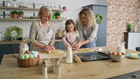 Video of three generations of women preparing Easter cookies together. Shot with RED helium camera in 8K.