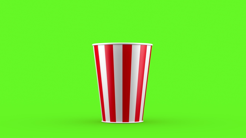 Popcorn falling out of a red-white striped bucket on a green background, nice background (4K,ultra high definition 2160p) Royalty-Free Stock Footage #1067972660