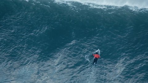 Nazaré, Portugal, 3 March 2020: A surfer paddle to overtake the wave
