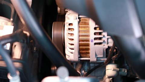 Spinning car alternator in the cars. Automotive concept.