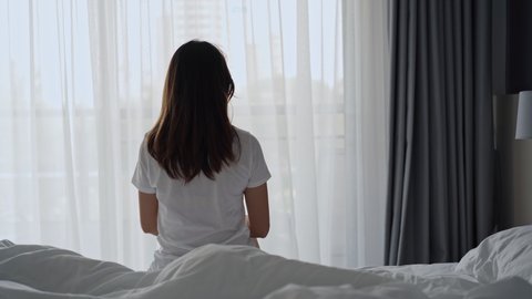 Woman suffering from back ache on the bed, healthcare and problem concept