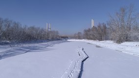 Frozen Vistula Bay of Water in Warsaw. In the background, a bridge and a panorama of Warsaw.