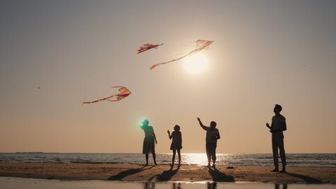 Friendly multi-generational family spends time together, playing with kites