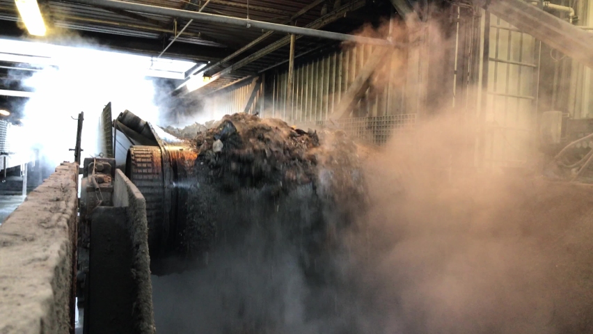 Incinerated household waste falls from a conveyor belt. | Shutterstock HD Video #1067992409