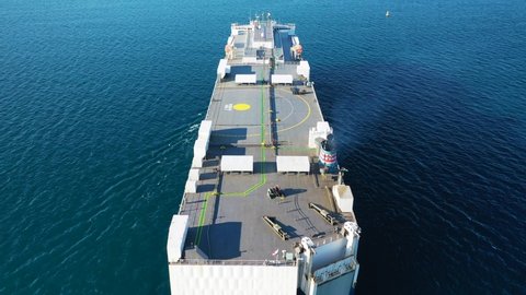 Aerial drone video of huge car carrier ship RO-RO (Roll on Roll off) cruising in Mediterranean deep blue ocean sea