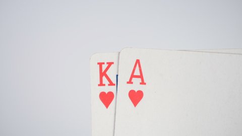 Two playing cards ace of hearts and carol of hearts on white background