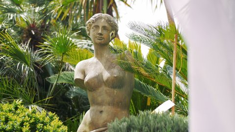 Marble statue of woman with white linen cloth in the foreground