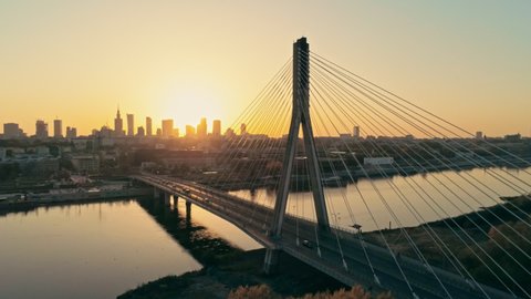 Establishing Aerial Panoramic Shot of Warsaw Cityscape, capital of Poland. Swietokrzyski Bridge and Downtown Skyline at Golden Sunset. Panning Background Drone view Video with Copy Space