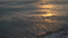 Beautiful defocused stock footage of blurry sunny morning sunrise blue and gold sea water. Abstract blur natural video bokeh background