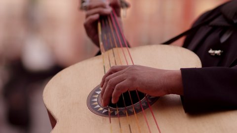 mariachi guitar close up playing on street Mexico.