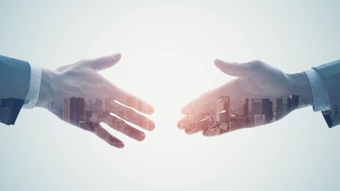 Silhouette of men shaking hands and modern cityscape. Double exposure.