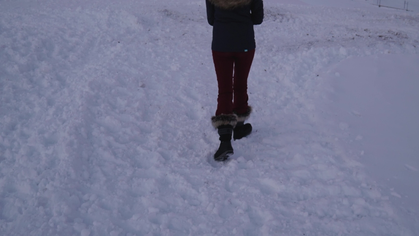 Zermatt , Switzerland - 01 24 2021: Girl walking infront of Famous Matterhorn Mountain at sunrise, red dawn sky winter wonderland at swiss alps zermatt glacier ski resort