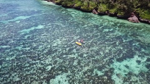 Nukuʻalofa , Tonga - 01 26 2018: Two people on a kayak and paddle board in Tonga