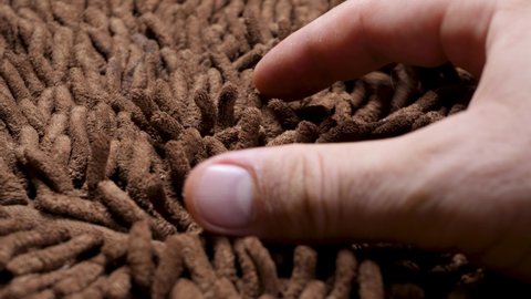 Brown soft carpet. True macro close up revealing it's texture. Gentle and fluffy micro fiber between fingers. Hand touch