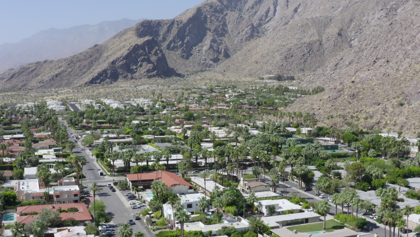 Small Town Neighborhood Houses Surrounded by Mountains Forward Aerial Tilt Up