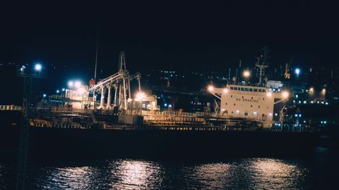 A night in the port with lights. Ship at the pier