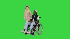 Caucasian lady pushes her disabled friend and leaves him waiting on a Green Screen, Chroma Key. - Powered by Shutterstock - Get 15% off with code: PIKWIZARD15