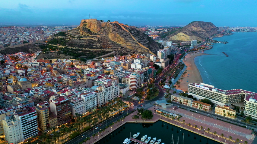 Sunset over the city center and port of Alicante city, Spain. Also the medieval fortess of Santa Barbara. Royalty-Free Stock Footage #1068050258