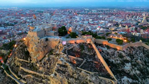 Sunset over the city center and port of Alicante city, Spain. Also the medieval fortess of Santa Barbara.