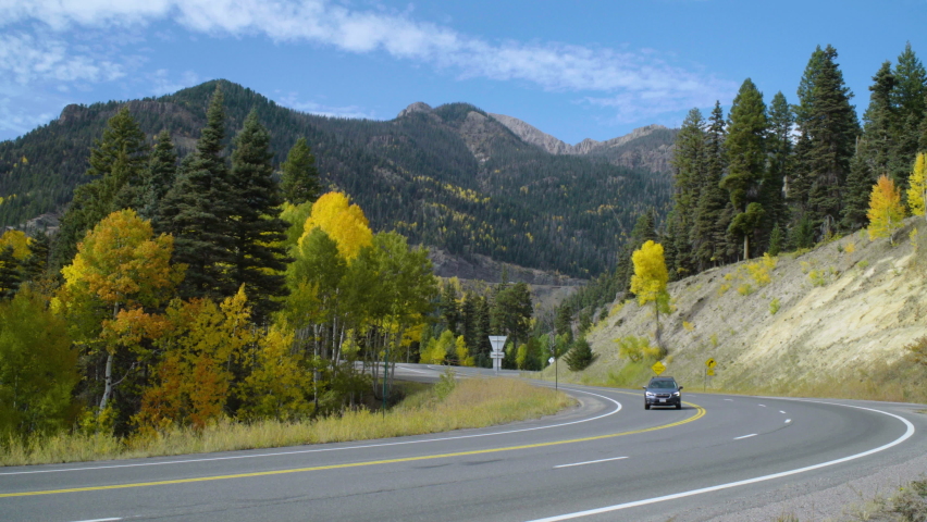 Curve on the road 160 with mountain range in the background. Clips of US 160 heading to Treasure Falls Colorado and two of Treasure Falls signs and area. In Pagosa Springs, Colorado, U.S.