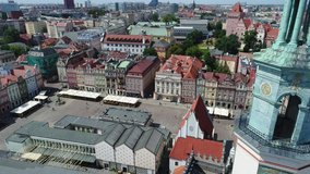View from the drone on the old market square in Poznań. In the foreground, a church hoop. Historical tenement houses in the background.