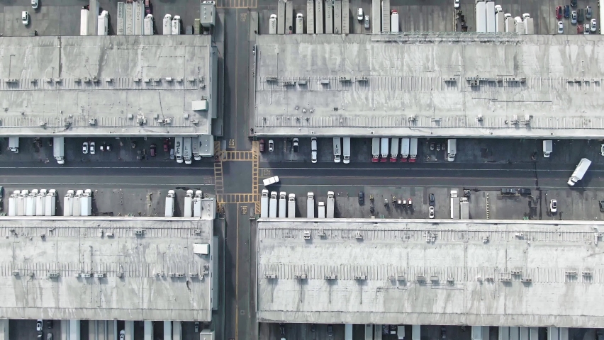 Aerial view of distribution warehouse. trucks delivering coronavirus covid-19 vaccine, vaccine shipment. usa public vaccination production and rollout. Royalty-Free Stock Footage #1068064115