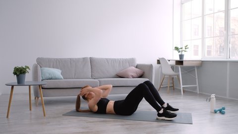 Sporty Lady Doing Abs Crunches Exercise Lying On Floor At Home. Abdominal Muscles Workout, Domestic Training And Fitness Lifestyle Concept. Side View