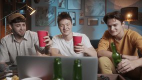 Diverse international friends celebration birthday toasting on video chat call, students Christmas celebration online during coronavirus lockdown, mens party with beer and football. - Powered by Shutterstock - Get 15% off with code: PIKWIZARD15