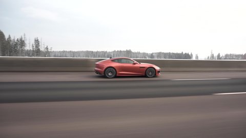 Moscow, Russia - CIRCA 2021: red Jaguar F-type R Coupe driving fast on the highway. Side view.