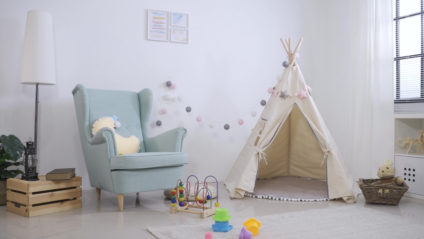 cute play tent. toys and single sofa in children’s game room with white wall background and nobody on a sunny day. Royalty-Free Stock Footage #1068078173