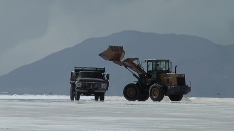 Salt Miners collecting Salt in a Salt Mine using a Wheel Loader and Old Truck in Salinas Grandes (Great Salt Flats), Salta, Argentina, South America. 