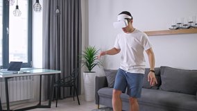 Man in futuristic virtual reality glasses does sports and plays with a virtual soccer ball, sports using modern technology in self-isolation. - Powered by Shutterstock - Get 15% off with code: PIKWIZARD15