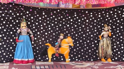 Traditional Indian Puppet Show of Rajasthan showing dancing puppets which are traditional form of fun and entertainment. Puppets are also known as Kathputli in Hindi Language