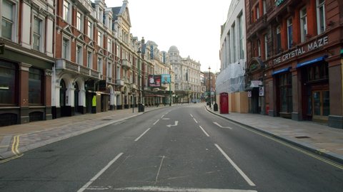London , England , United Kingdom (UK) - 06 01 2020: Lockdown in London, slow motion gimbal walk along empty Shaftesbury Avenue with closed theatres and restaurants, during the Coronavirus pandemic 20