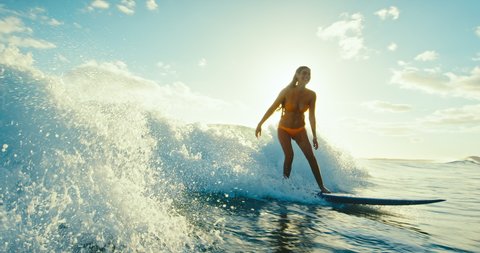 Beautiful girl surfing ocean wave at sunset, beautiful ocean wave, surf lifestyle, cinematic slow motion, shot on RED camera