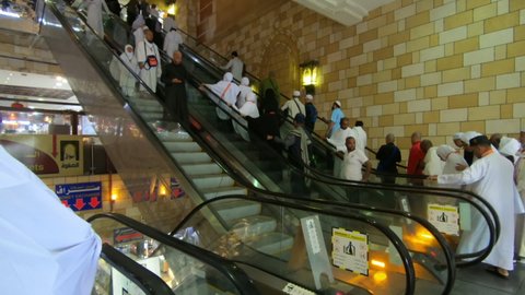 Muslim Commuters on the escalator of Arabian shopping Mall, Mecca, Saudi Arabia, 19 December 2019 