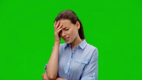 Tired girl suffering from painful headache and stress. Young girl in blue shirt holding hand on forehead on green background. Medical concept. Alpha channel - Powered by Shutterstock - Get 15% off with code: PIKWIZARD15